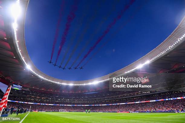 The Patrulla Aguila performs prior to the La Liga match between Atletico Madrid and Malaga at Wanda Metropolitano stadium on September 16, 2017 in...
