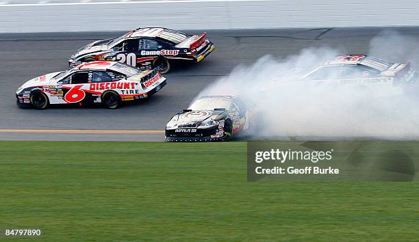 Mike Bliss, driver of the Miccosukee Resorts Chevrolet spins as David Ragan, driver of the Discount Tire Ford and Joey Logano, driver of the GameStop...