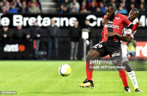 Guingamp's French forward Yannis Salibur vies with Lille's French defender Fode Ballo Toure during the French L1 football match Guingamp against...