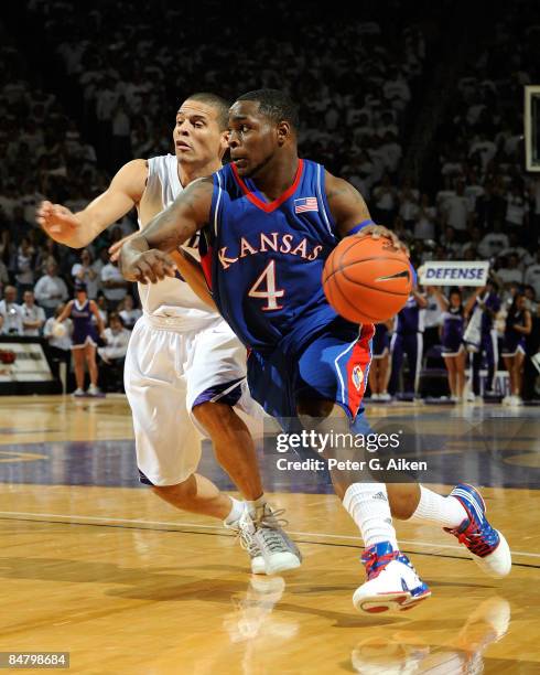 Sherron Collins of the Kansas Jayhawks drives to the basket past Denis Clemente of the Kansas State Wildcats during the first half on February 14,...