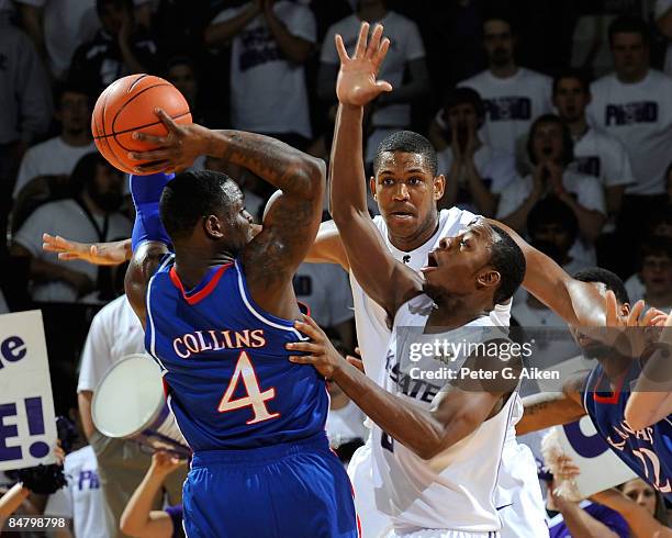Jacob Pullen and Luis Colon of the Kansas State Wildcats pressure Sherron Collins of the Kansas Jayhawks look during the second half on February 14,...