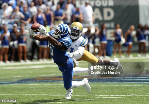 Anthony Miller of the Memphis Tigers catches a pass against Darnay Holmes of the UCLA Bruins on September 16, 2017 at Liberty Bowl Memorial Stadium...