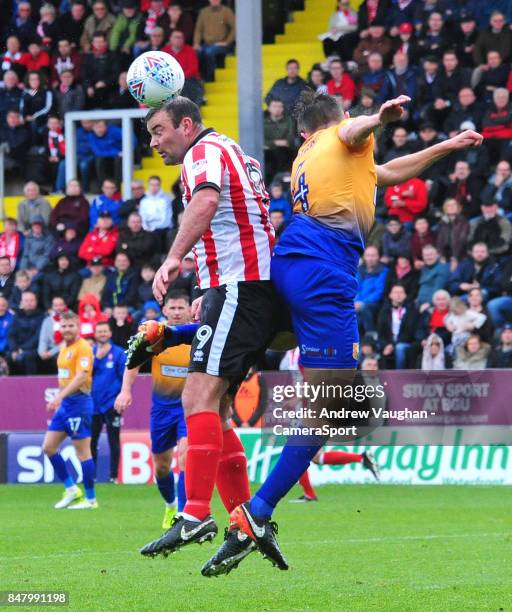 Lincoln City's Matt Rhead vies for possession with Mansfield Town's Paul Digby during the Sky Bet League Two match between Lincoln City and Mansfield...