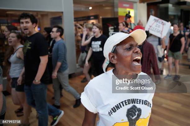 Demonstrators march through the West County Mall protesting the acquittal of former St. Louis police officer Jason Stockley on September 16, 2017 in...