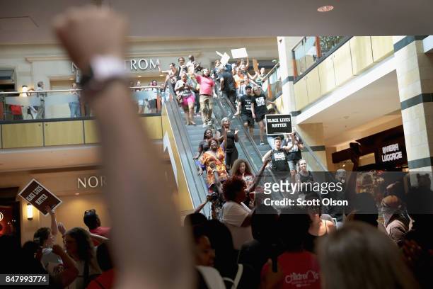 Demonstrators march through the West County Mall protesting the acquittal of former St. Louis police officer Jason Stockley on September 16, 2017 in...