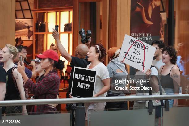 Demonstrators march through the West County Mall protesting the acquittal of former St. Louis police officer Jason Stockley on September 16, 2017 in...