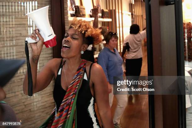 Demonstrators march through the West County Mall protesting the acquittal of former St. Louis police officer Jason Stockley on September 16, 2017 in...