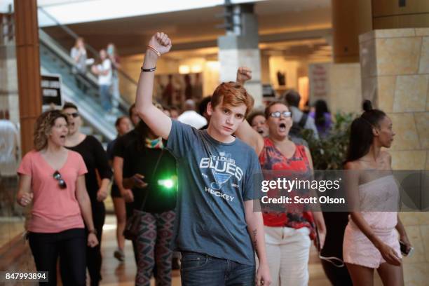 Demonstrators march through the West County Mall protesting the acquittal of former St. Louis police officer Jason Stockley on September 16, 2017 in...