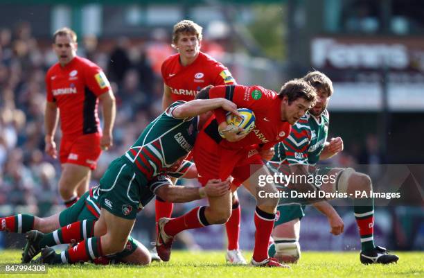 Saracens Alex Goode is tackled by Leicester's Anthony Allen and George Chuter during the Aviva Premiership Semi Final match at Welford Road,...