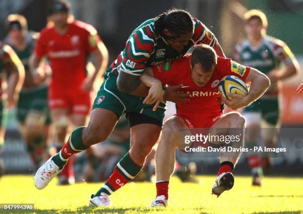 Saracens' James Short is tackled by Leicester's Alesana Tuilagi during the Aviva Premiership Semi Final match at Welford Road, Leicester.