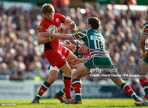 Saracens David Strettle is tackled byLeicester's Ben Youngs and George Ford during the Aviva Premiership Semi Final match at Welford Road, Leicester.