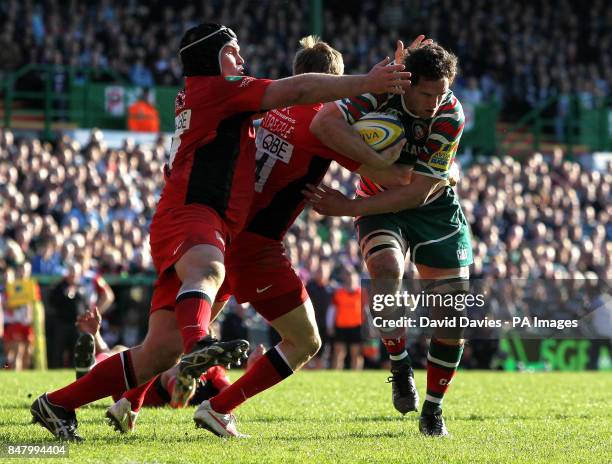 Leicester's Craig Newby is tackled by Saracens David Strettle and Matt Stevens during the Aviva Premiership Semi Final match at Welford Road,...