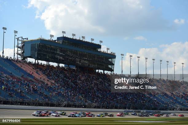 Erik Jones, driver of the NBA 2K18/GameStop Toyota, and Daniel Suarez, driver of the Comcast Business/Juniper Toyota, lead the field to turn one...