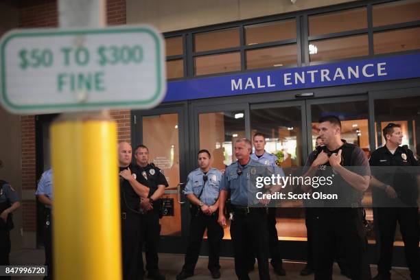 Police guard an entrance to the West County Mall after demonstrators marched through protesting the acquittal of former St. Louis police officer...