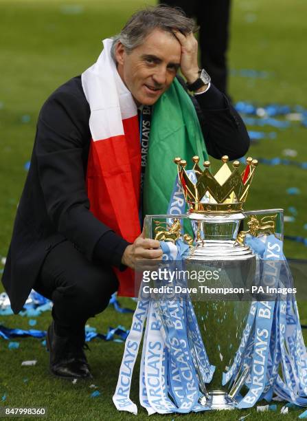 Manchester City manager Roberto Mancini with the trophy during the Barclays Premier League match at the Etihad Stadium, Manchester.