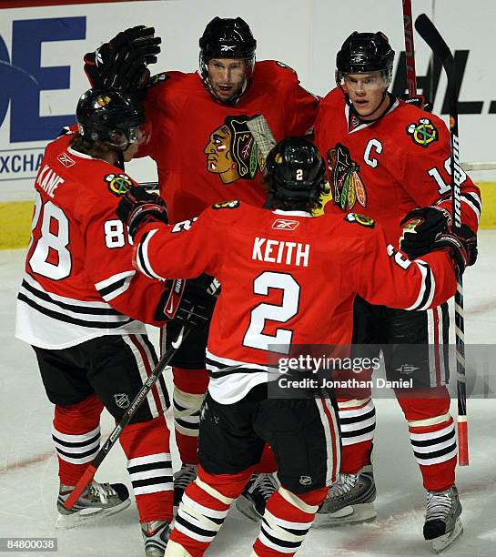 Troy Brouwer of the Chicago Blackhawks celebrates his first period goal against the Dallas Stars with teammates Patrick Kane, Duncan Keith and...