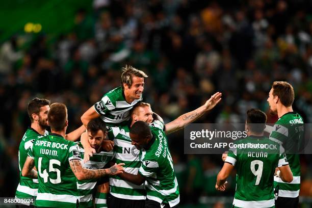 Sporting's French defender Jeremy Mathieu celebrates with teammates after scoring during the Portuguese league football match Sporting CP vs CD...