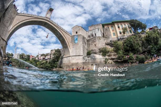 In this handout image provided by Red Bull, Kris Kolanus of Poland dives from the 27 metre platform on Stari Most during the fifth stop of the Red...