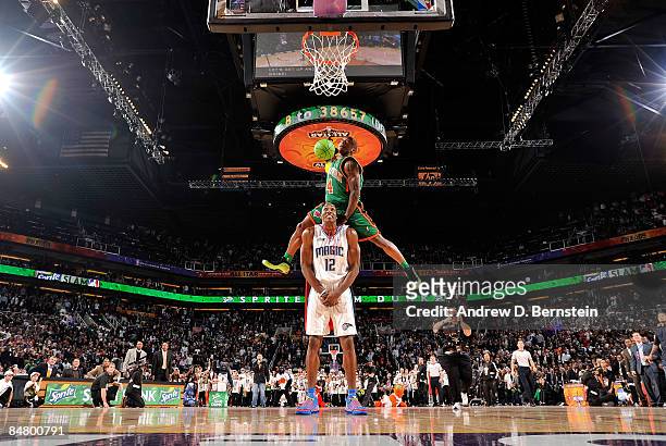 Nate Robinson of the New York Knicks dunks over Dwight Howard of the Orlando Magic in the finals of the Sprite Slam Dunk Contest on All-Star Saturday...