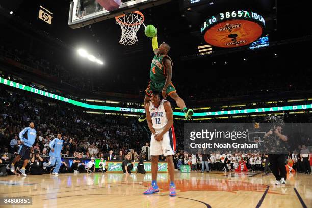 Nate Robinson of the New York Knicks dunks over Dwight Howard of the Orlando Magic in the finals of the Sprite Slam Dunk Contest on All-Star Saturday...