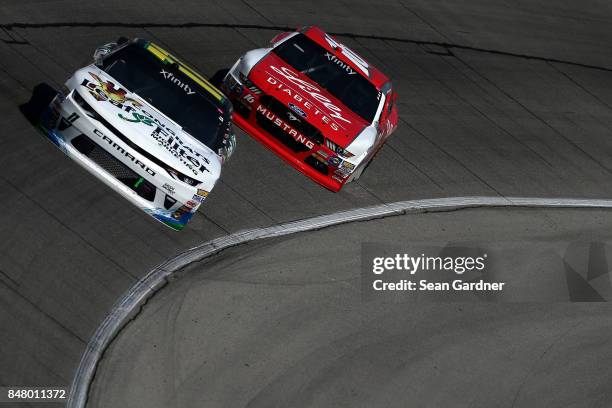 Blake Koch, driver of the LeafFilter Gutter Protection Chevrolet, leads Ryan Reed, driver of the Lilly Diabetes Ford, during the NASCAR XFINITY...