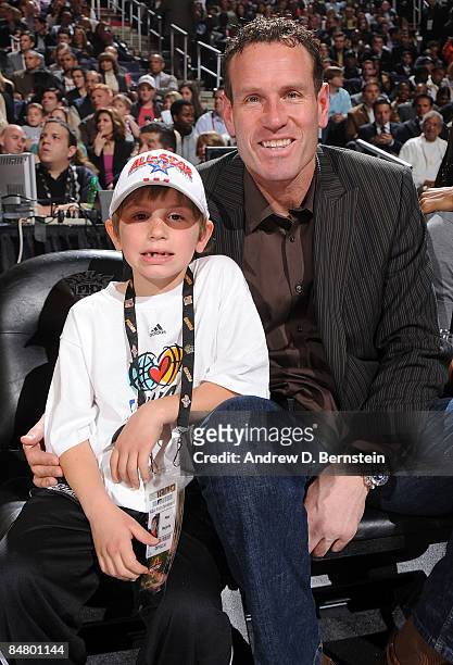 Former Phoenix Suns player Dan Majerle sits with son Max Majerle during Foot Locker Three-Point Shootout on All-Star Saturday Night, part of 2009 NBA...