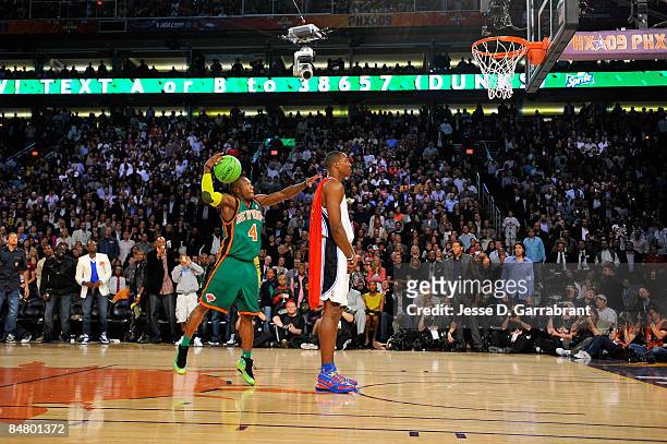 Nate Robinson of the New York Knicks jumps over Dwight Howard of the Orlando Magic on a dunk attempt during the Sprite Slam Dunk Contest on All-Star...