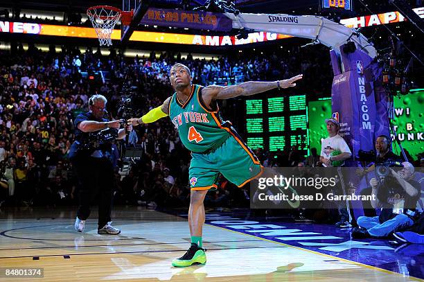 Nate Robinson of the New York Kinicks does the "Superman" dance after he completed a dunk over Dwight Howard of the Orlando Magic participates in the...