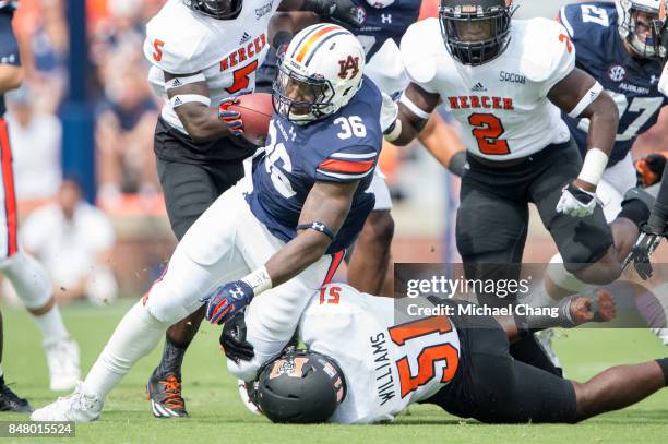 Running back Kamryn Pettway of the Auburn Tigers attempts to escape a tackle by linebacker Kyle Williams of the Mercer Bears at Jordan-Hare Stadium...