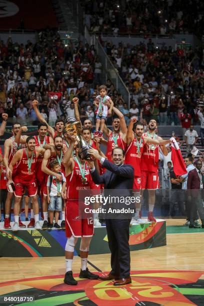 Prime Minister of Tunisia Youssef Chahed presents the trophy to Ben Romdhane of Tunisia after Tunisia wins the AfroBasket 2017 final round basketball...