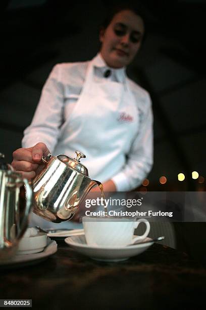 Waitress pours tea at Bettys Tea Room, Harlow Carr on February 12, 2009 in Harrogate, England. The family owned company Taylors of Harrogate have...