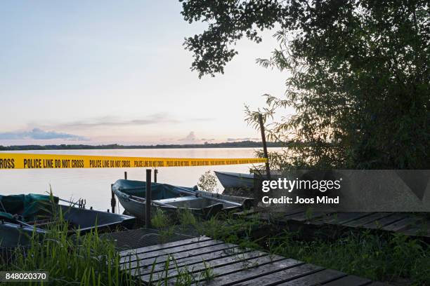 crime scene at a lake in the evening - crime scene stockfoto's en -beelden