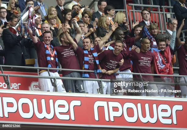 West Ham United's captain Kevin Nolan lifts the Championship Play-Off Trophy as he celebrates with his team mates