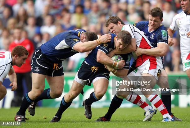 Leinster's Gordon D'Arcy is tackled by Ulster's Darren Cave during the Heinken Cup Final at Twickenham, London.