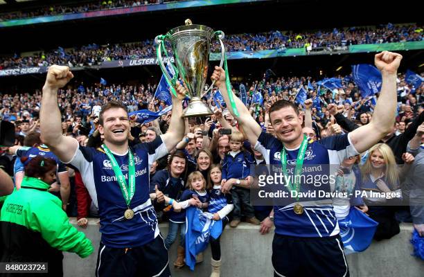 Leinster's Gordon D'Arcy and Brian O'Driscoll celebrate with the trophy after victory over Ulster during the Heinken Cup Final at Twickenham, London.