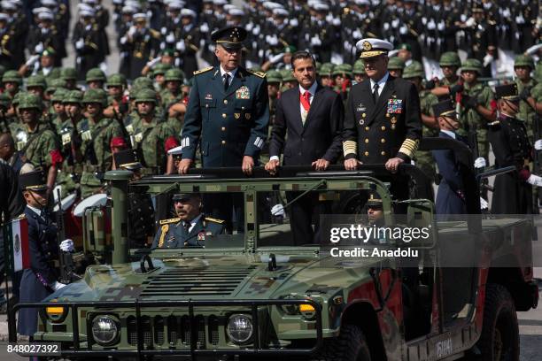 President of Mexico Enrique Pena Nieto flanked by Defense Secretary Salvador Cienfuegos Zepeda and Admiral Vidal Francisco Soberon Sanz review the...