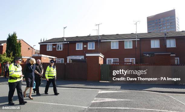 Home Secretary Theresa May walks around the St George's Estate in Hulme, Manchester, with Inspector Nail Pawson of Greater Manchester Police, local...