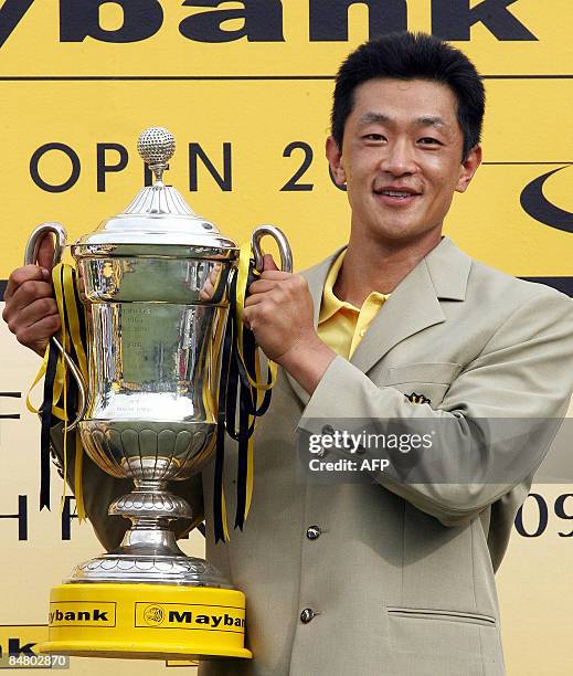 Anthony Kang of the US poses with the trophy after winning the Maybank Malaysian Open golf tournament in Subang on the outskirts of Kuala Lumpur on...