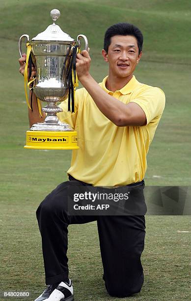 Anthony Kang of the US poses with the trophy after winning the Maybank Malaysian Open golf tournament in Subang on the outskirts of Kuala Lumpur on...