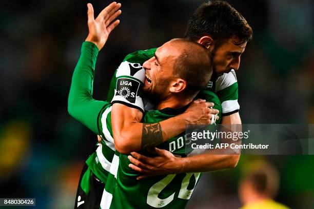 Sporting's midfielder Bruno Fernandes celebrates with his teammate Sporting's Dutch forward Bas Dost after scoring during the Portuguese league...