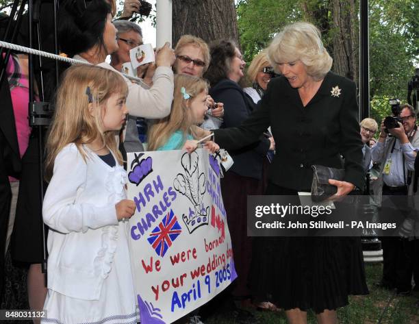 The Duchess of Cornwall, with twin sisters Grace and Helena Jordan, aged 7, who were born on her wedding day to the Prince of Wales, during a visit...