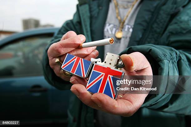 Woman holds a lighter for sale at Wimbledon car boot sale and market on February 15, 2009 in London, England. Cyril Waterman has been running the...