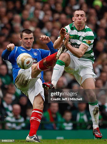 Scott Brown of Celtic is tackled by Lee McCulloch of Rangers during the Scottish Premier League match between Celtic and Rangers at Celtic Park on...