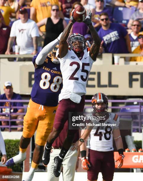 Cornerback Greg Stroman of the Virginia Tech Hokies intercepts a pass intended for wide receiver Trevon Brown of the East Carolina Pirates in the...