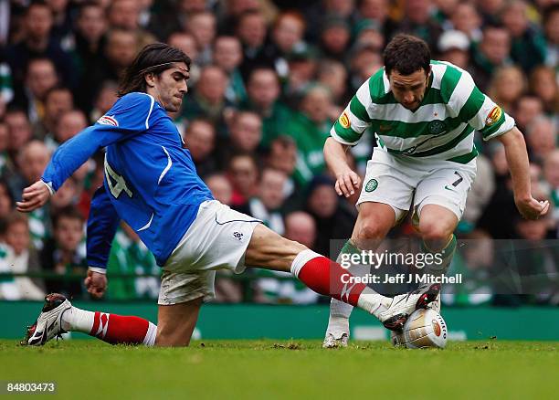 Scott McDonald of Celtic tackles Pedro Mendes of Rangers during the Scottish Premier League match between Celtic and Rangers at Celtic Park on...