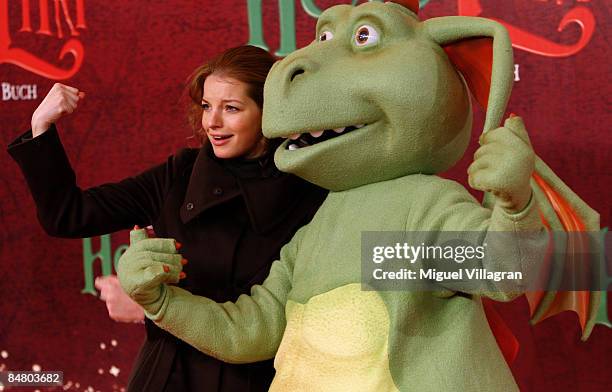 Yvonne Catterfeld poses for the media with Hector the dragon during the premiere of the movie 'Lilli The Witch - The Dragon And The Magical Book' on...