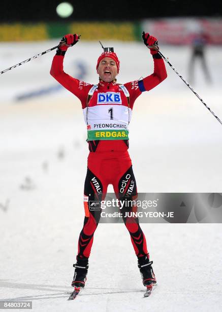 Norway's Ole Einar Bjoerndalen reacts as he crosses the finish line during the men's 12.5 km pursuit event at the IBU World Biathlon Championships in...