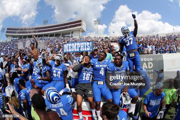 The Memphis Tigers celebrate their victory with fans against the UCLA Bruins on September 16, 2017 at Liberty Bowl Memorial Stadium in Memphis,...