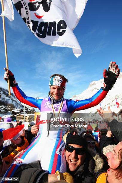 Silver medal winner Julien Lizeroux of France celebrates with fans and team mates following the Men's Slalom event held on the Face de Bellevarde...