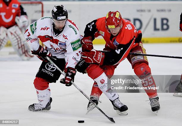 Christoph Ullmann of Hannover and Patrick Koeppchen of Koelner Haie compete for the puck during the DEL Bundesliga game between Hannover Scorpions...